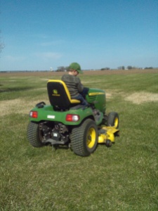 Not many things will keep the farm boy out of the field, but mowing lawn seems to be better than planting corn for him. 